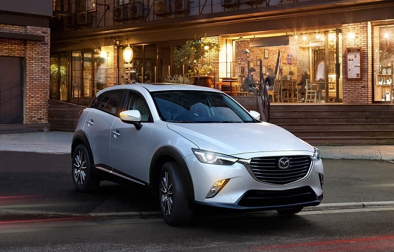 View of ceramic metallic 2017 Mazda CX-3 parked outside an urban cafe