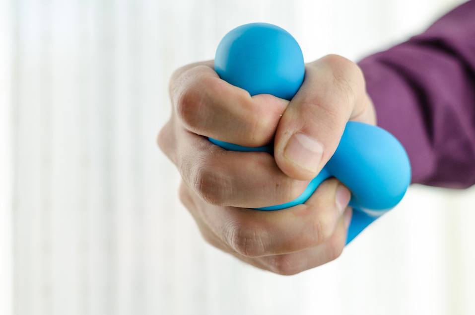 Anti-stress balls in hand, according to the window with bright sunlight