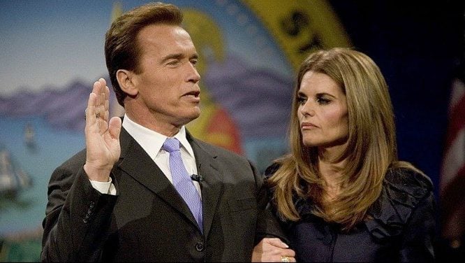 Arnold Schwarzenegger and Maria Shriver stand together as he is being sworn into office.