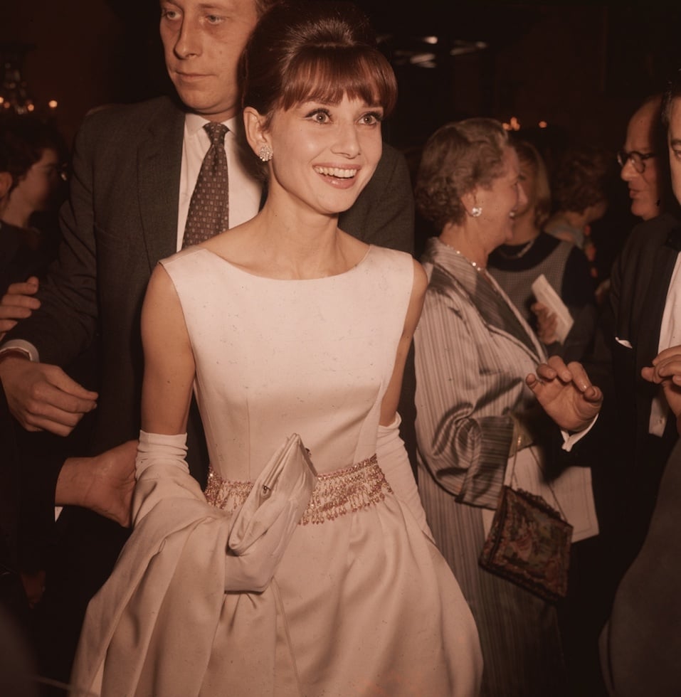 Belgian-born actress Audrey Hepburn (1929 - 1993) wearing a white satin evening gown and long gloves