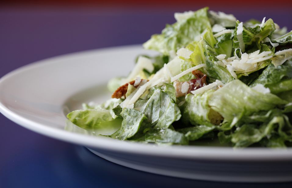 Caesar salad with homemade bacon.