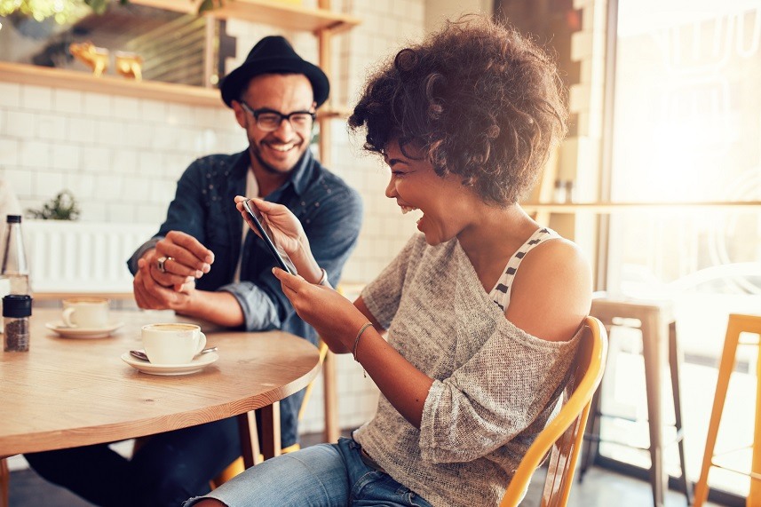 smiling young woman at a cafe table