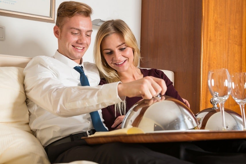 Couple with tray of room service food