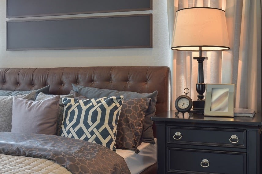 bedroom interior with pillows and reading lamp