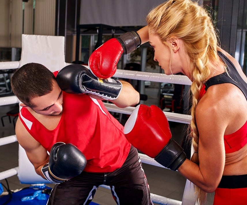 two people boxing in a gym two people boxing in a gym