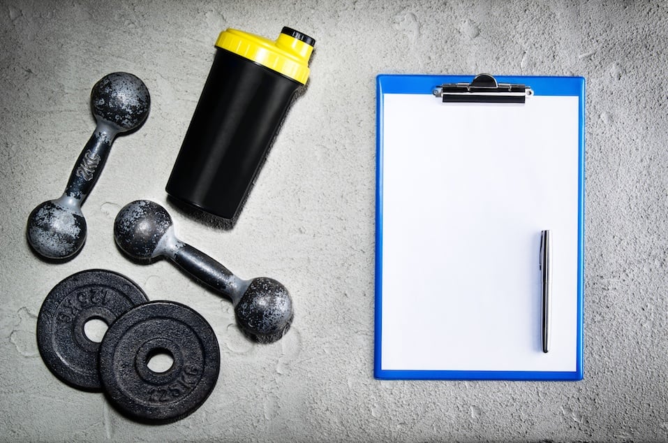 Fitness or bodybuilding background. Old iron dumbbells on conrete floor