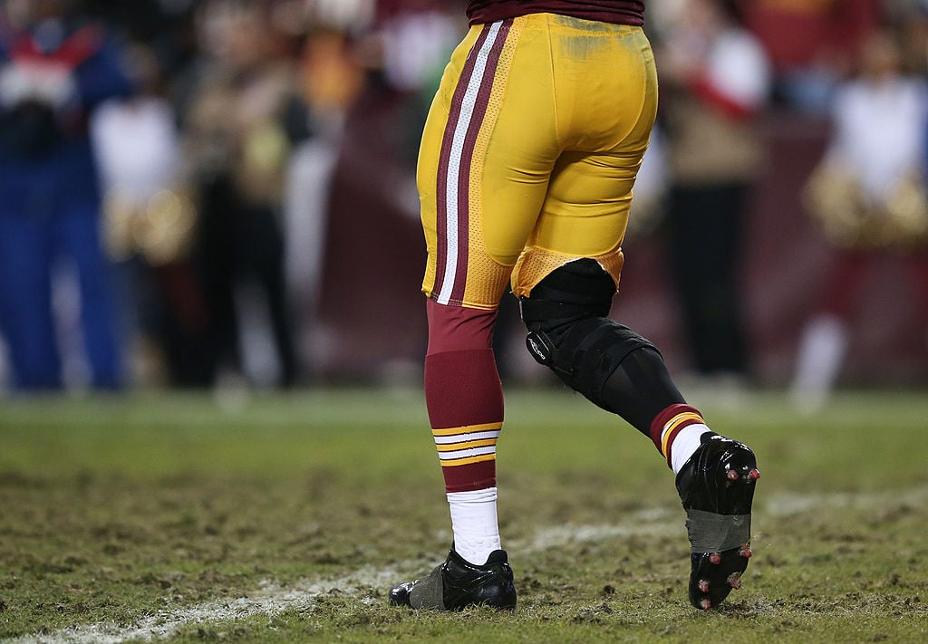 A football player wearing a knee brace during an NFL game