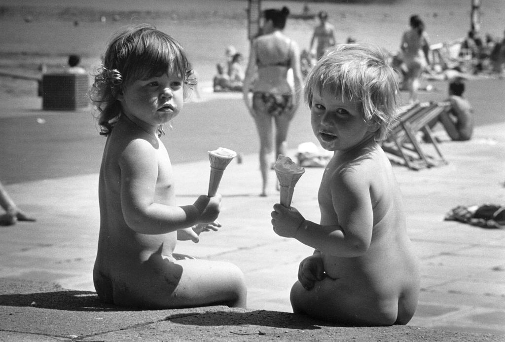 A couple of little girls sunbathing on the beach