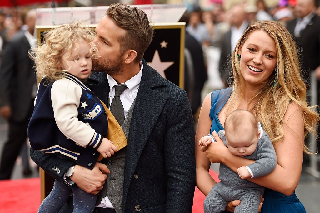 Blake Lively and Ryan Reynolds hold their daughters on the Hollywood Walk of Fame