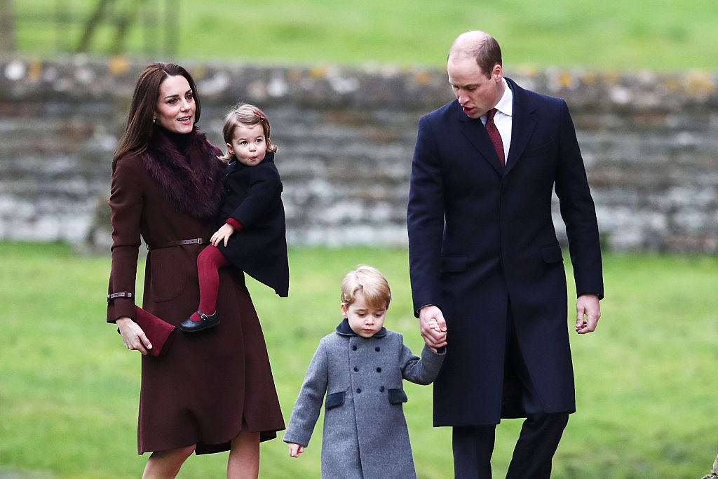 Kate Middleton, Prince William, and their children Charlotte and George walk together in winter clothing