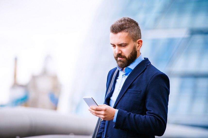 Hipster manager holding a smart phone