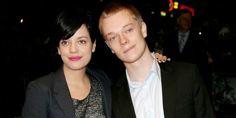 Lily Allen has her arm around Alfie Allen.