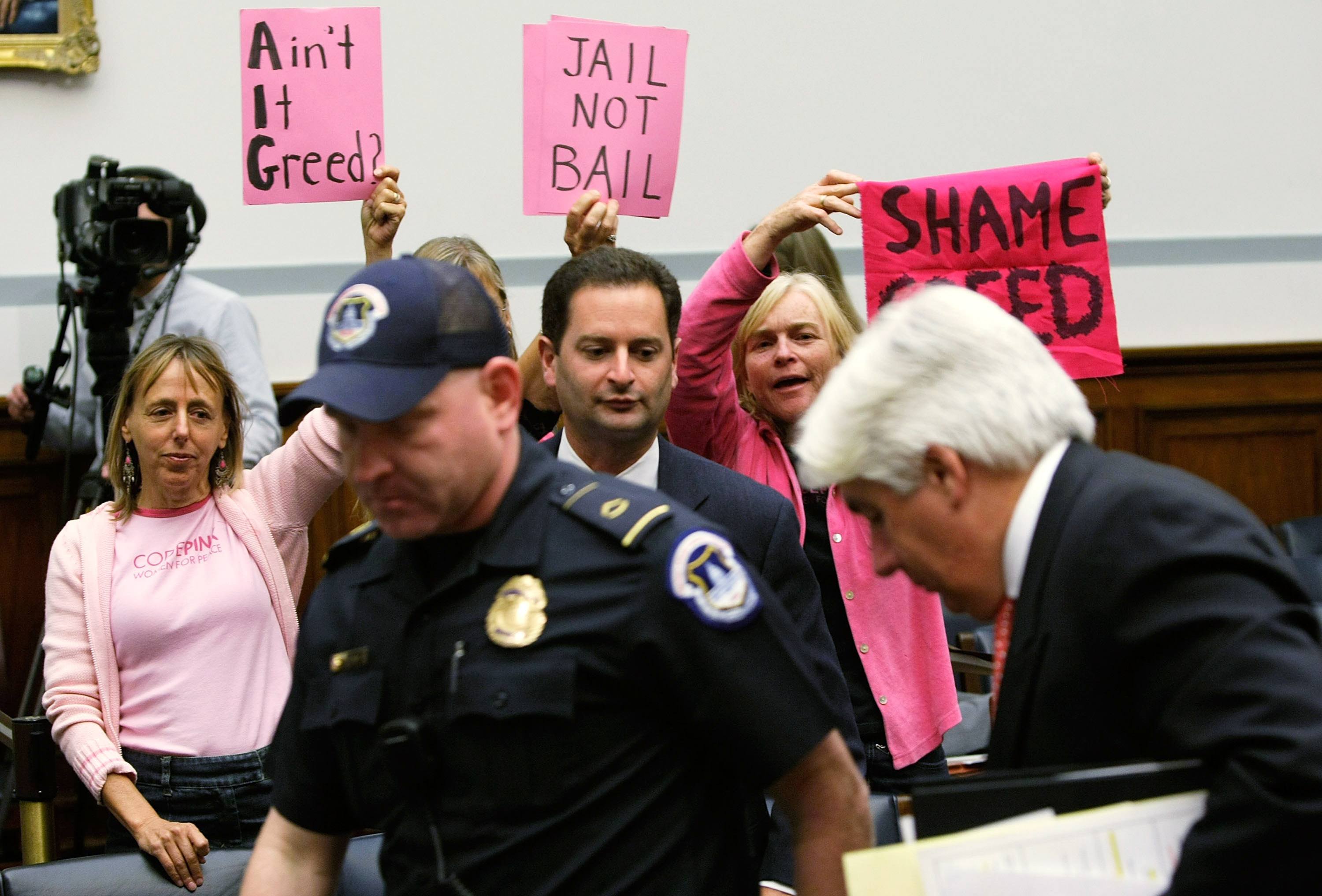 Members of Code Pink protest former AIG CEO Martin Sullivan.
