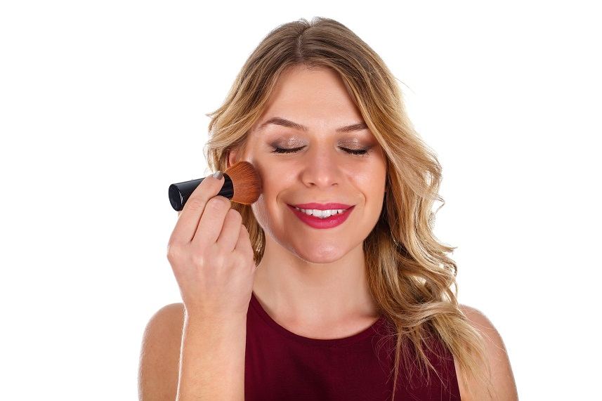 Beautiful woman finishing up her make-up