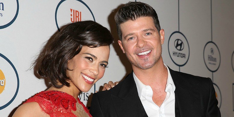 Paula Patton and Robin Thicke are posing together on the red carpet.