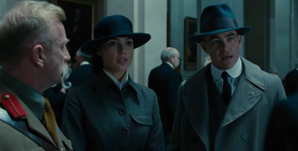 Wonder Woman and Steve Trevor wearing trenchcoats, having a conversation with two army officers