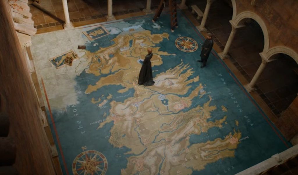 Cersei stands on top of a floor with a map of Westeros, with Jaime directly to her right