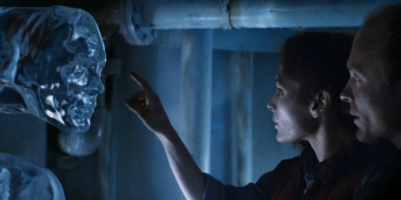 Mary Elizabeth Mastrantonio is about to touch a water creature in The Abyss.
