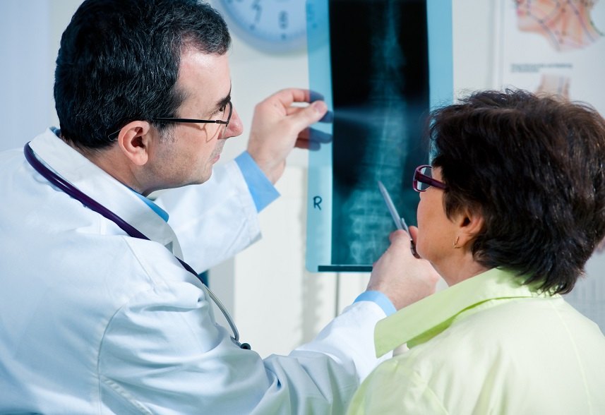 Doctor shows at an X-ray the problem areas Doctor shows at an X-ray the problem areas