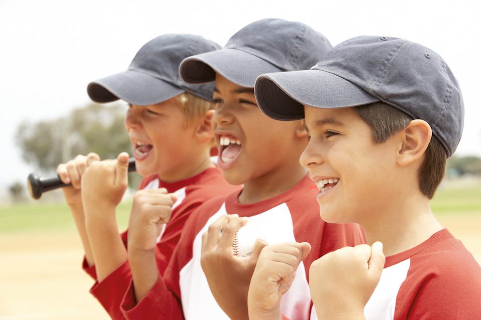 three boys in baseball uniforms