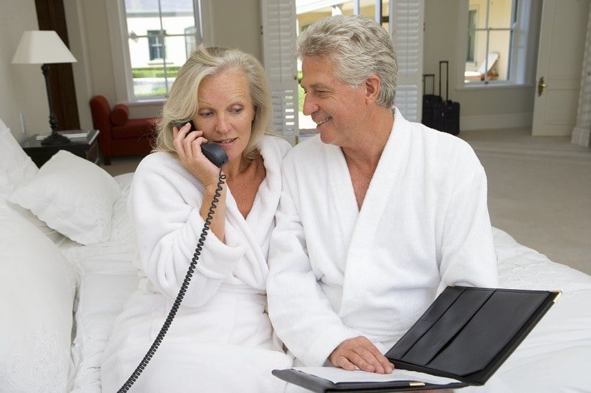 Mature couple sitting on bed