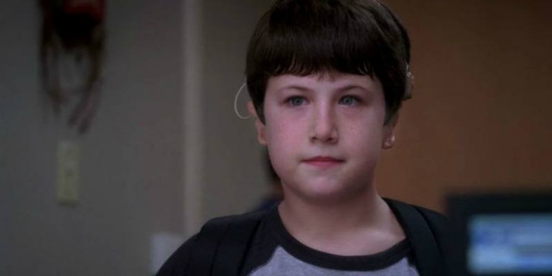 Dylan Minnette is standing with a backpack on in Grey's Anatomy.