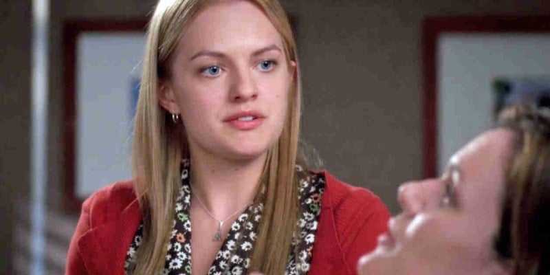 Elisabeth Moss is looking at a woman lying in a hospital bed.