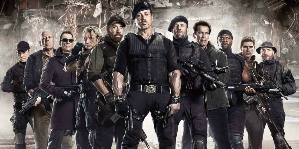 The cast of the Expendables dressed in all black, posing together for a promo photo