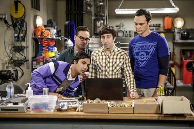 Raj, Leonard, Howard and Sheldon stand in front of a computer in a science lab in The Big Bang Theory |