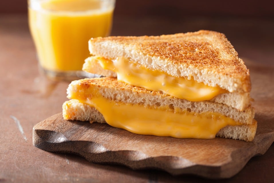 homemade grilled cheese sandwich on a wooden plate homemade grilled cheese sandwich on a wooden plate