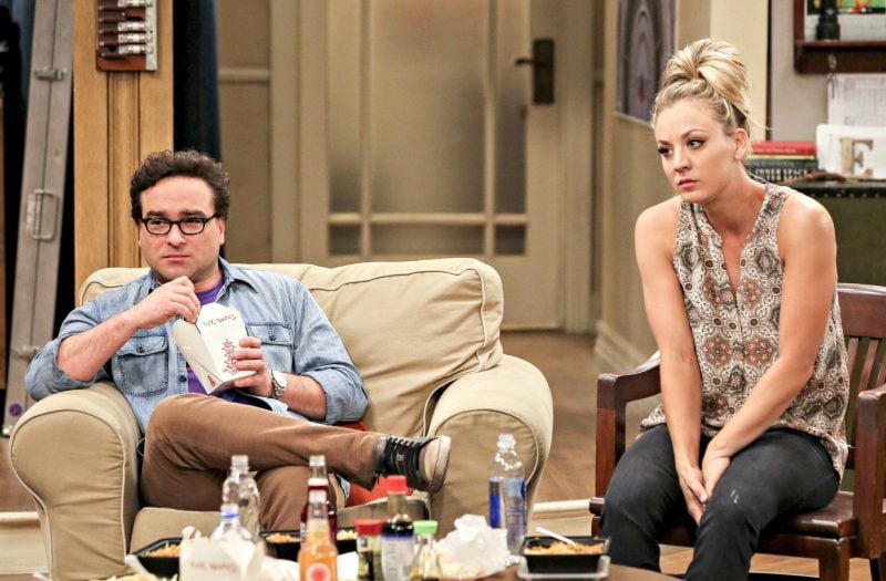 Leonard and Penny sit next to each other while eating Chinese food in The Big Bang Theory