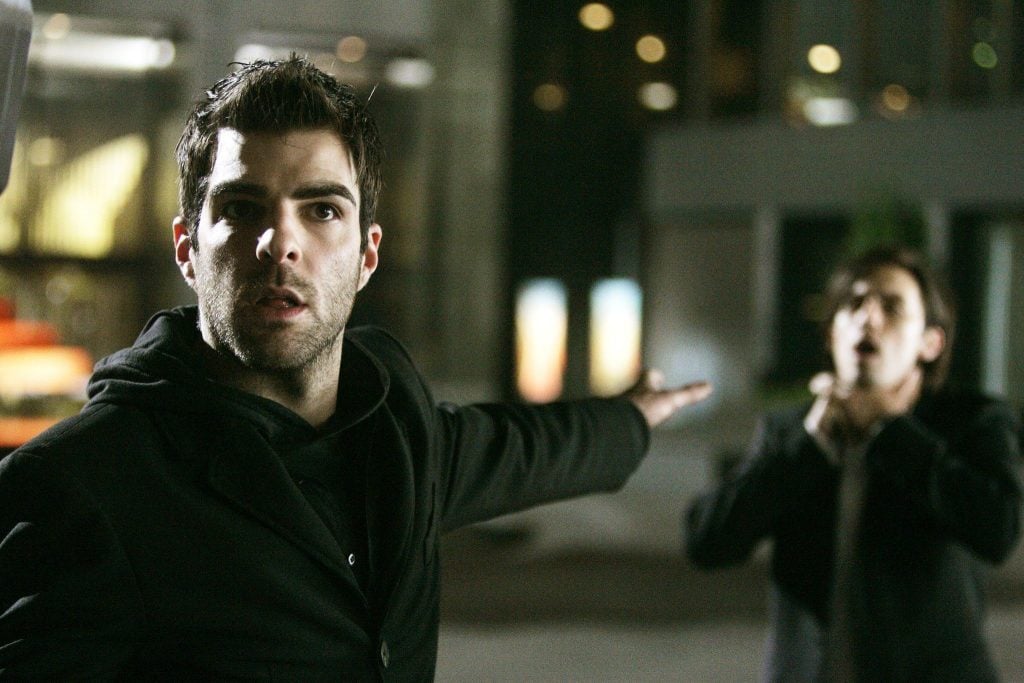 Zachary Quinto as Sylar, holding his left arm out, and telepathically choking his foe while looking into the camera
