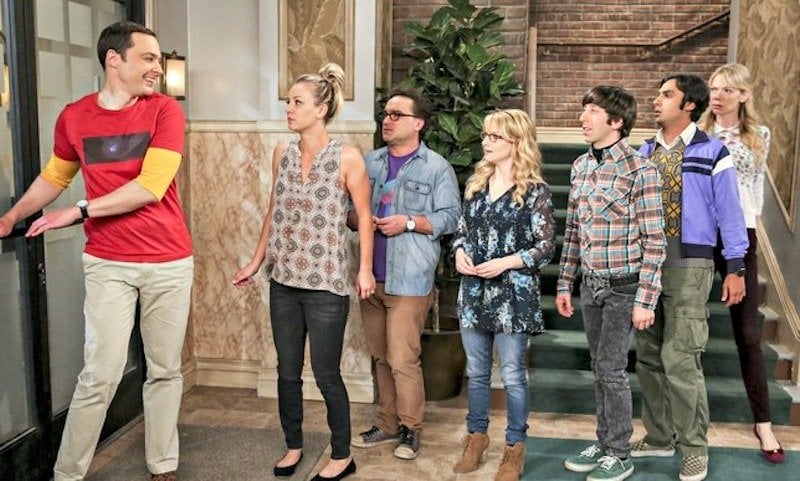Sheldon Cooper leads his group of friends in a line out the door on The Big Bang Theory.
