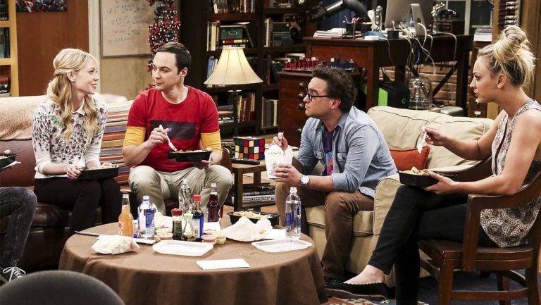 Ramona sits next to Sheldon on a couch and talks to Leonard and Penny in The Big Bang Theory