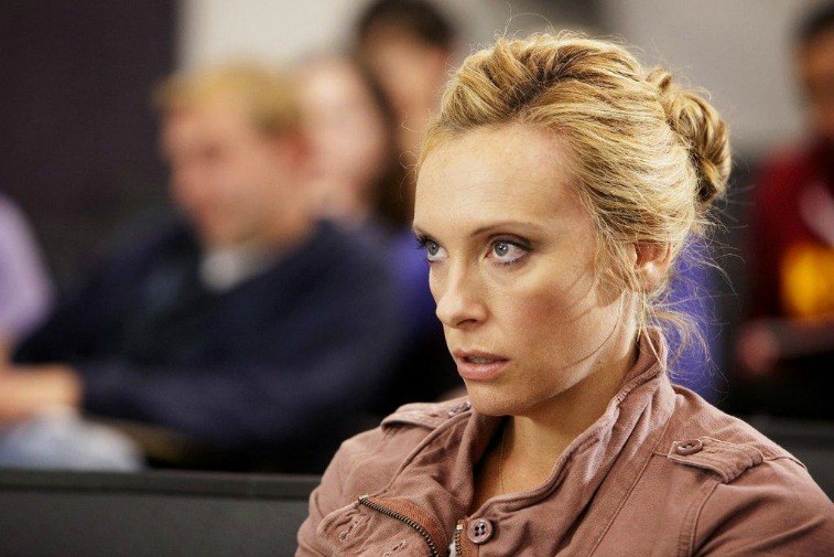 Toni Collette as Tara Gregson in a classroom staring ahead on United States of Tara
