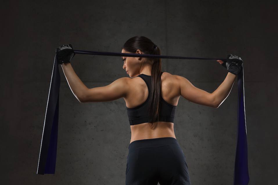 woman with expander exercising in gym