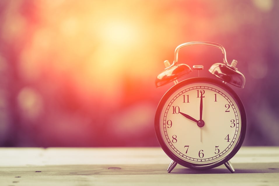 10 o'clock Clock Vintage on Wood Table with Sun Light