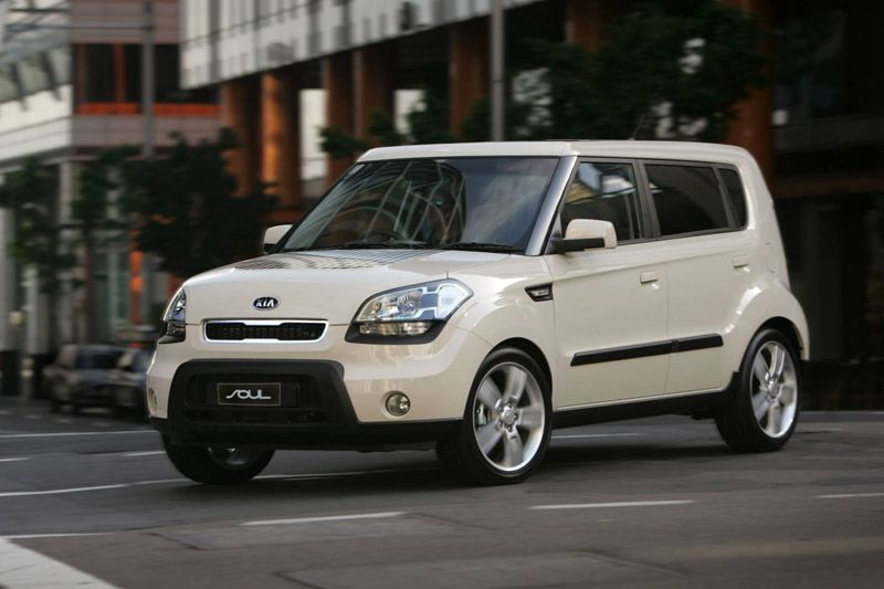 View of cream-colored 2012 Kia Soul on a city street