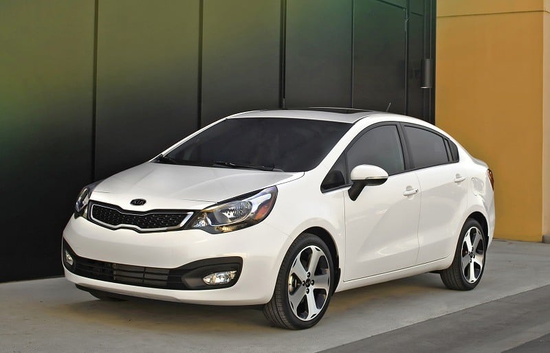 Front three quarter view of 2013 Kia Rio sedan in white