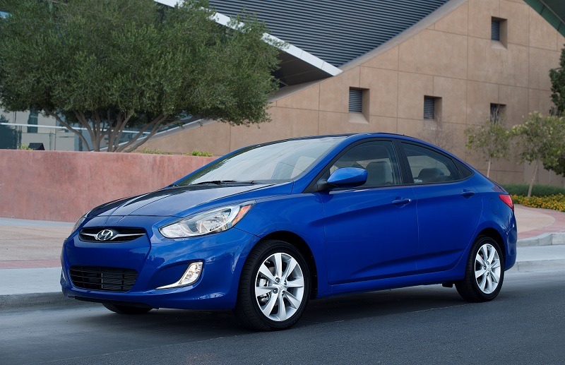 Front three quarter view of blue Accent sedan, model year 2013