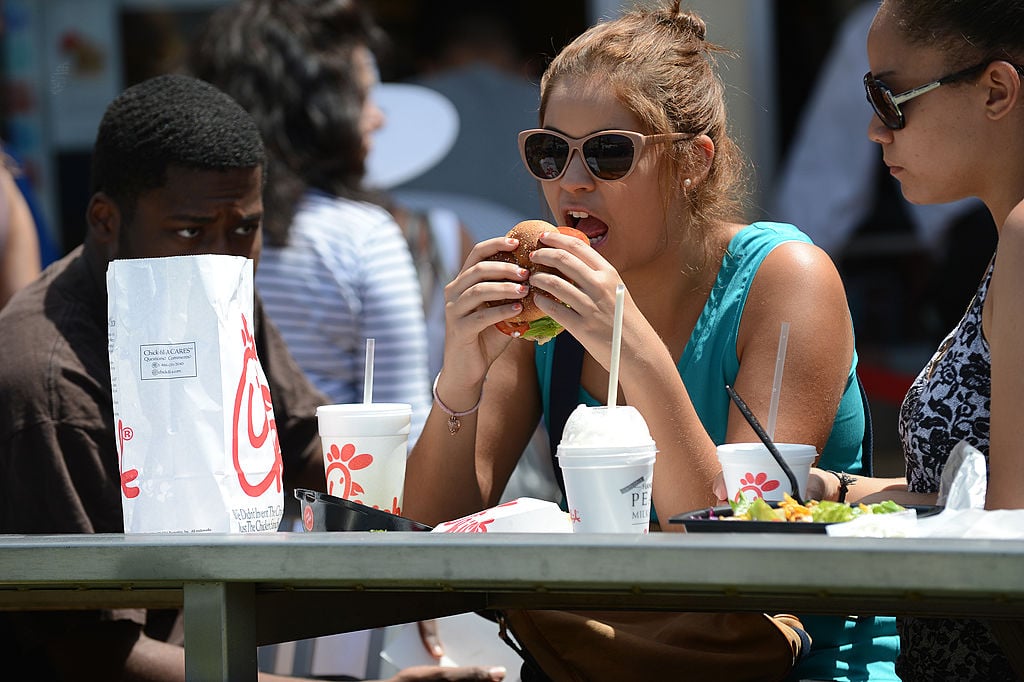 A woman eats lunch on the patio of the Chick-fil-A in Hollywood, California