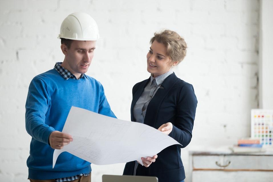 Two young colleagues at meeting looking at project concept
