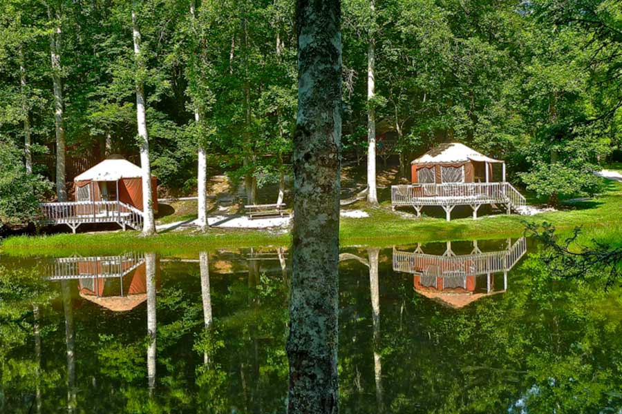 yurts by a pond