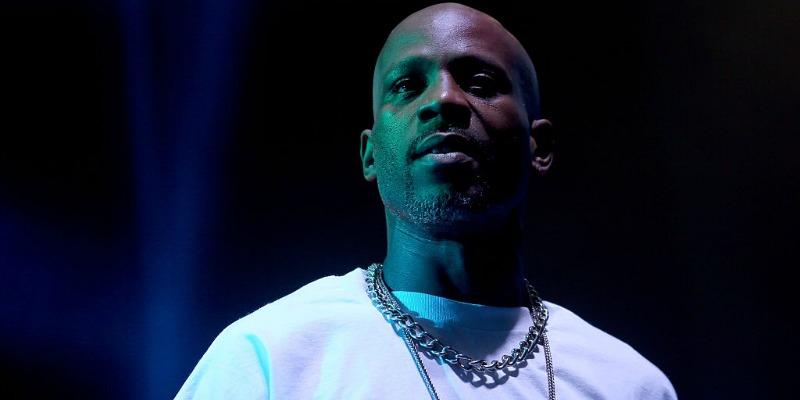 DMX is wearing white t-shirt as she stand on stage.