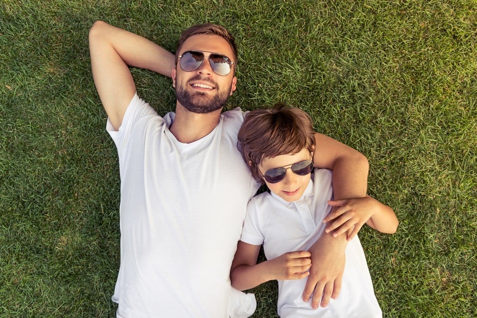 boy and his handsome young dad in white T-shirts