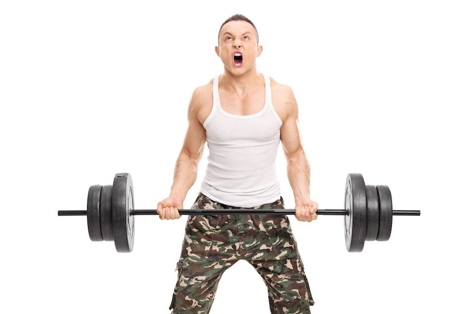 Young determined bodybuilder lifting a heavy weight