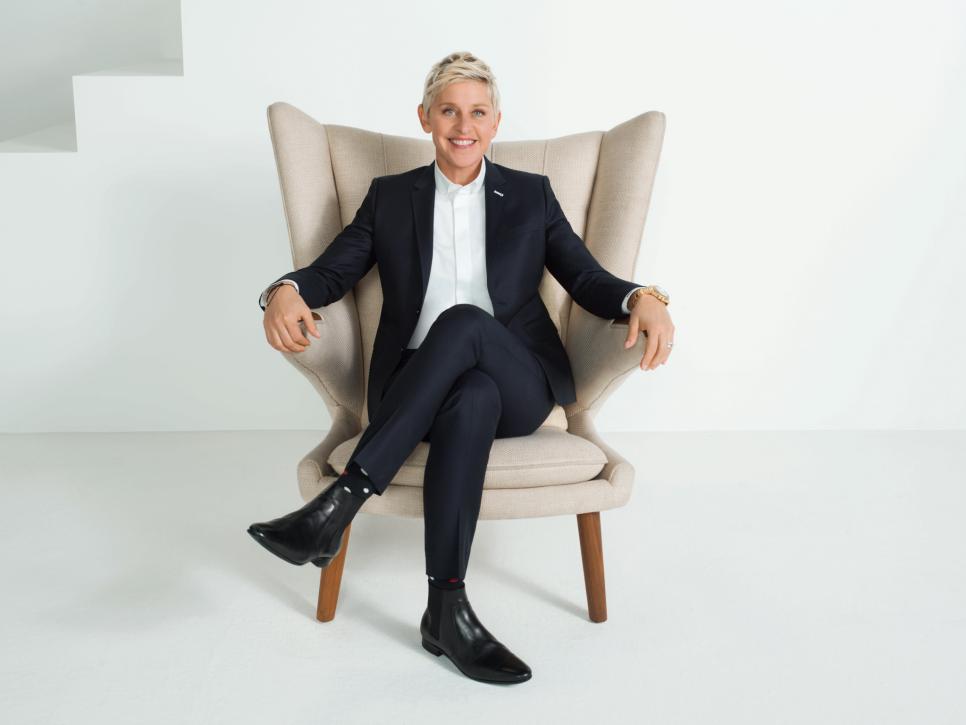 Ellen DeGeneres sits on a white chair.