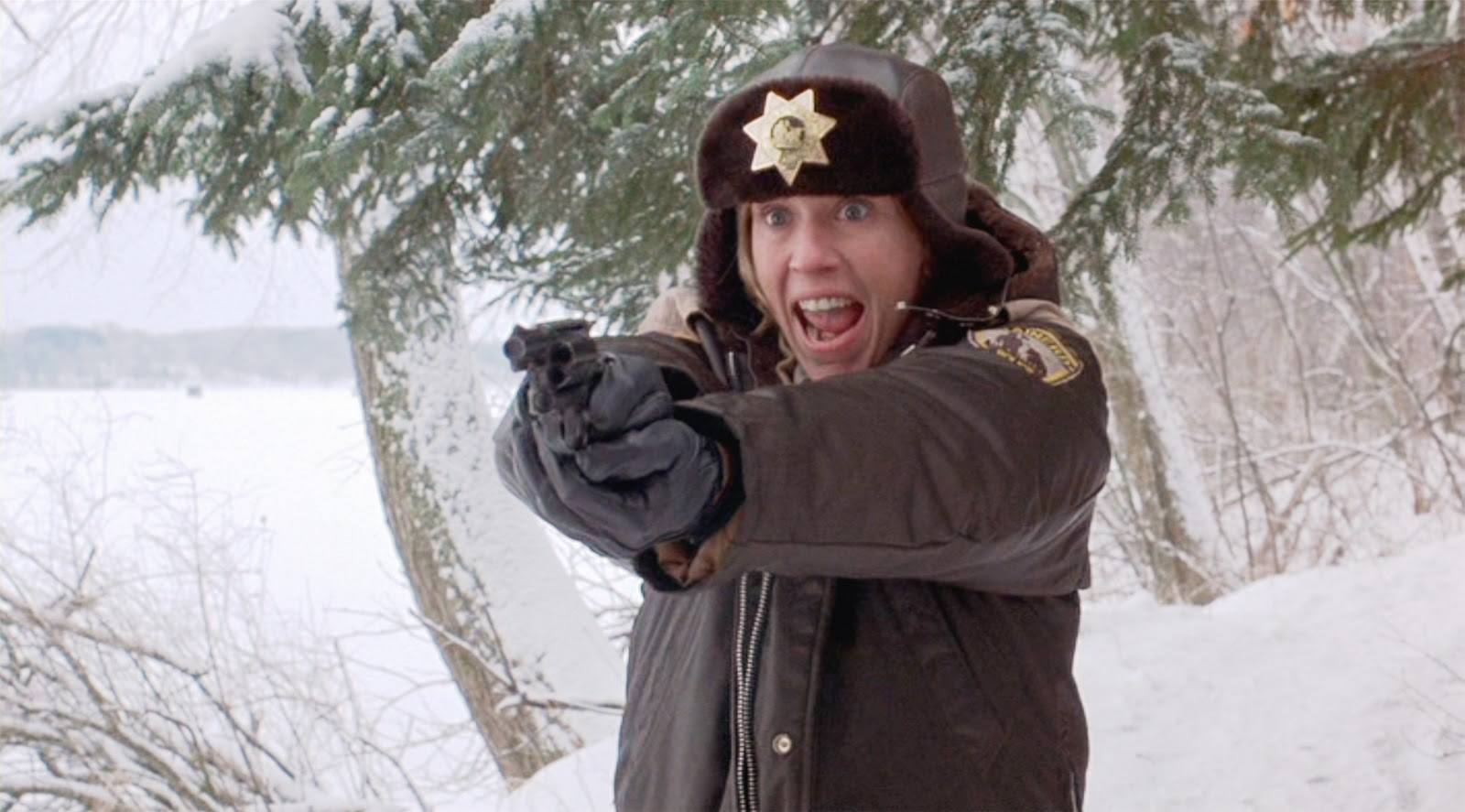A police-woman yells, while holding her gun out in front of her in both hands