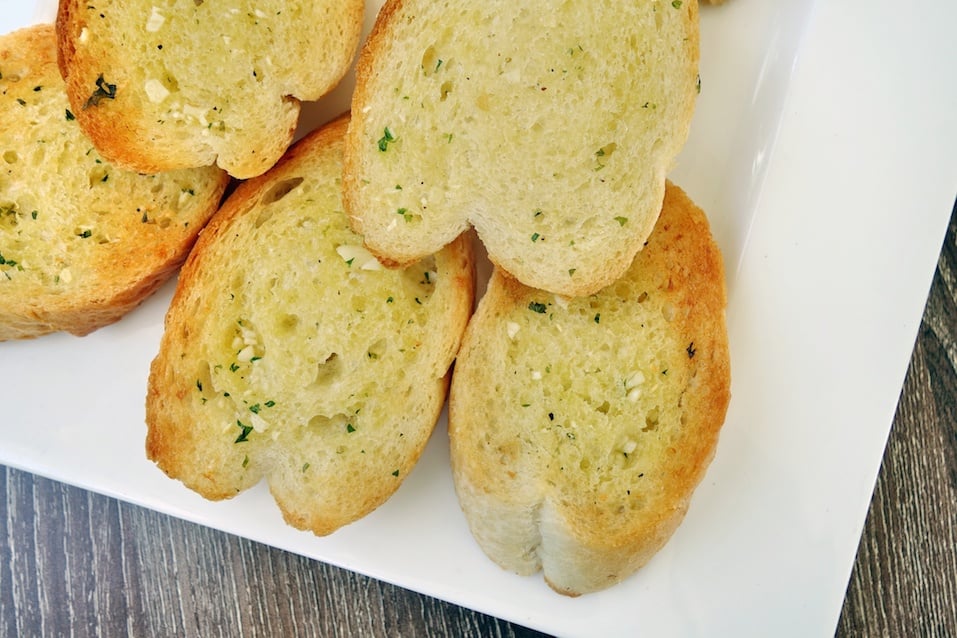 garlic bread on white plate