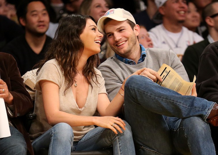 Actors Ashton Kutcher and Mila Kunis attend the game between the Oklahoma City Thunder and the Los Angeles Lakers at Staples Center.